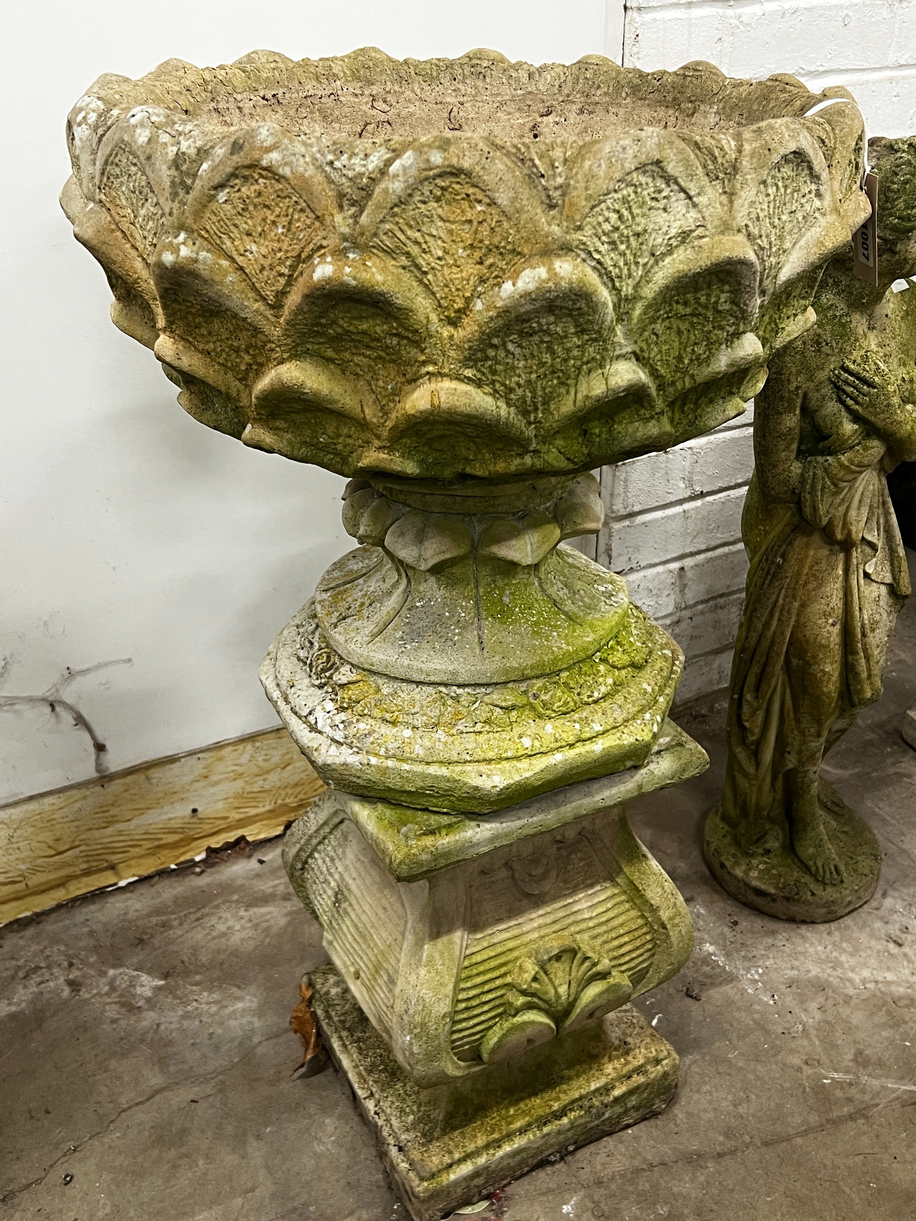 A reconstituted stone circular garden planter on square plinth, diameter 52cm, height 89cm